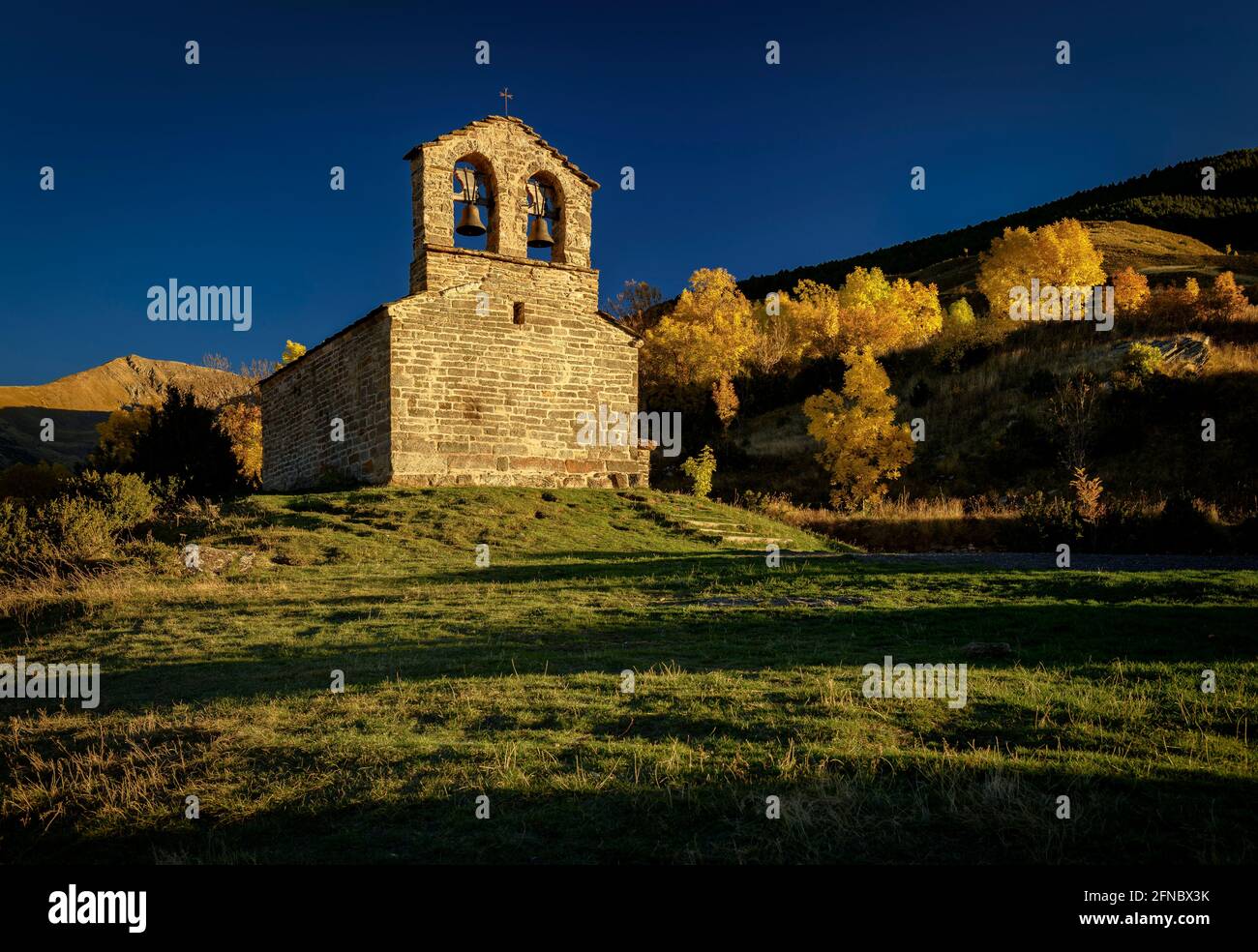 Sant Quirc de Durro Hermitage in an autumn sunset (Boí Valley, Catalonia, Spain, Pyrenees) ESP: Ermita de Sant Quirc de Durro en un atardecer otoñal Stock Photo