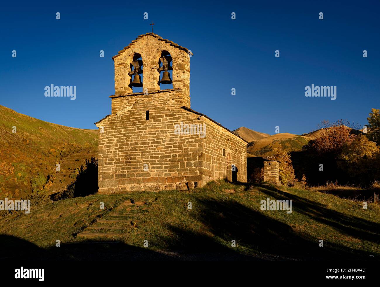 Sant Quirc de Durro Hermitage in an autumn sunset (Boí Valley, Catalonia, Spain, Pyrenees) ESP: Ermita de Sant Quirc de Durro en un atardecer otoñal Stock Photo