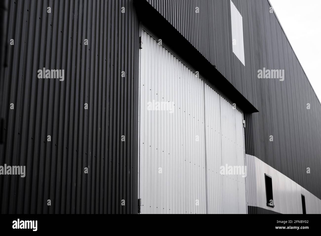 Black and white corrugated iron sheet used as a facade of a warehouse