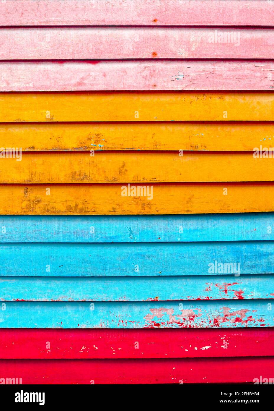 Colourful textured background of colourful, distressed horizontal wooden slats. Stock Photo