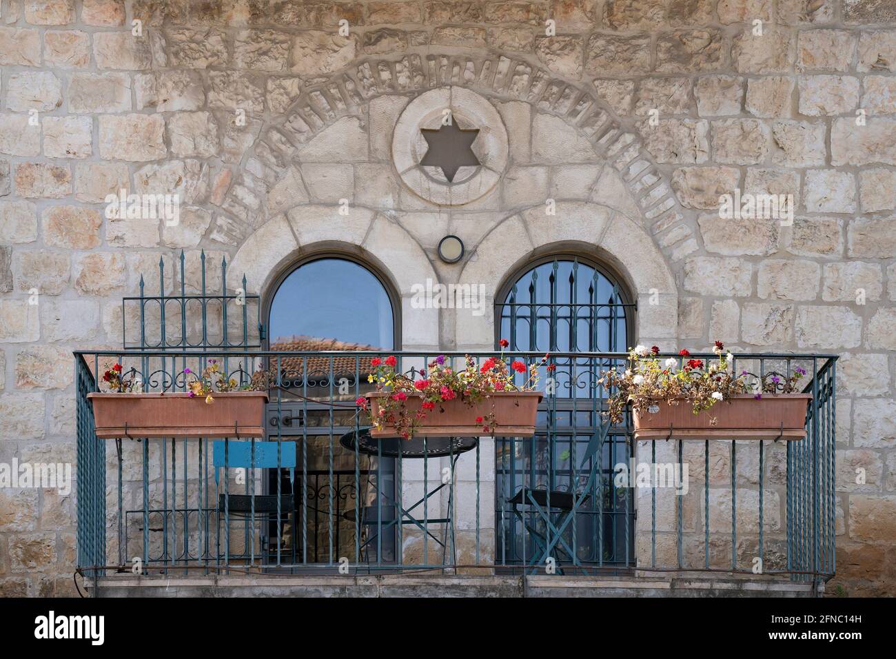 A typical balcony in the jewish houses of old jerusalem, with arched doors, decorated with a star of david. Stock Photo