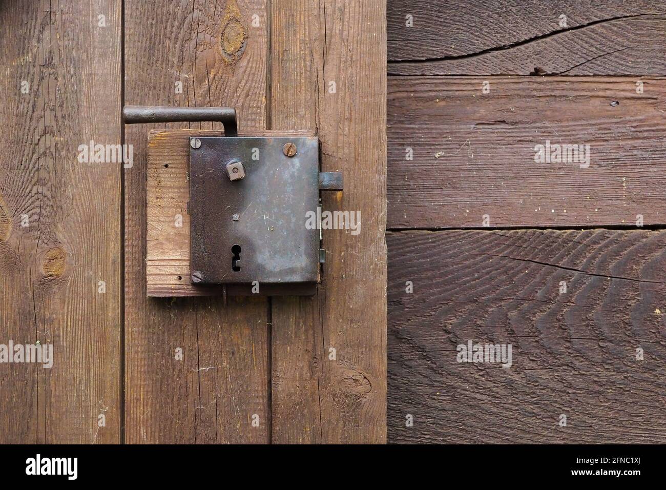 the old boarded-up barn door and the old lock Stock Photo - Alamy
