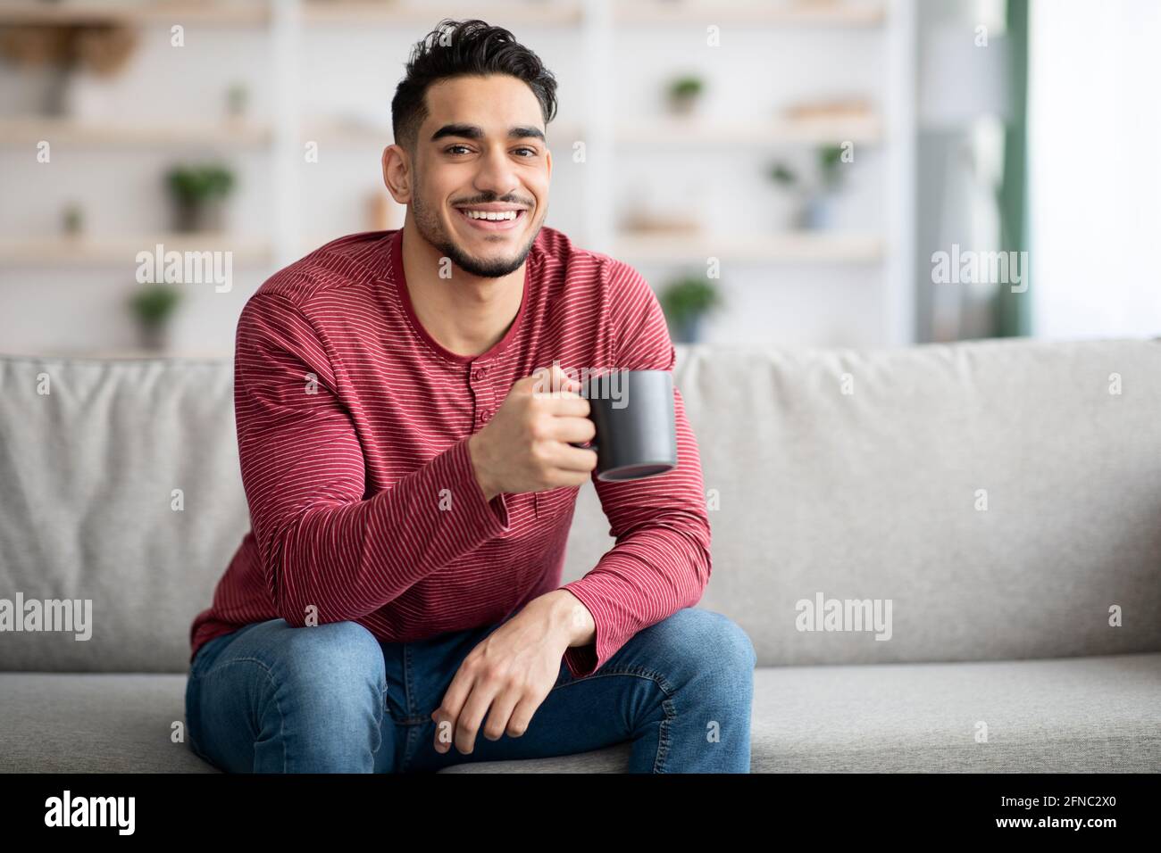 Cheerful arab man sitting hi-res stock photography and images - Alamy