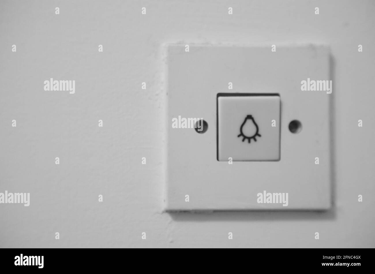 a white plastic light switch on the wall Stock Photo
