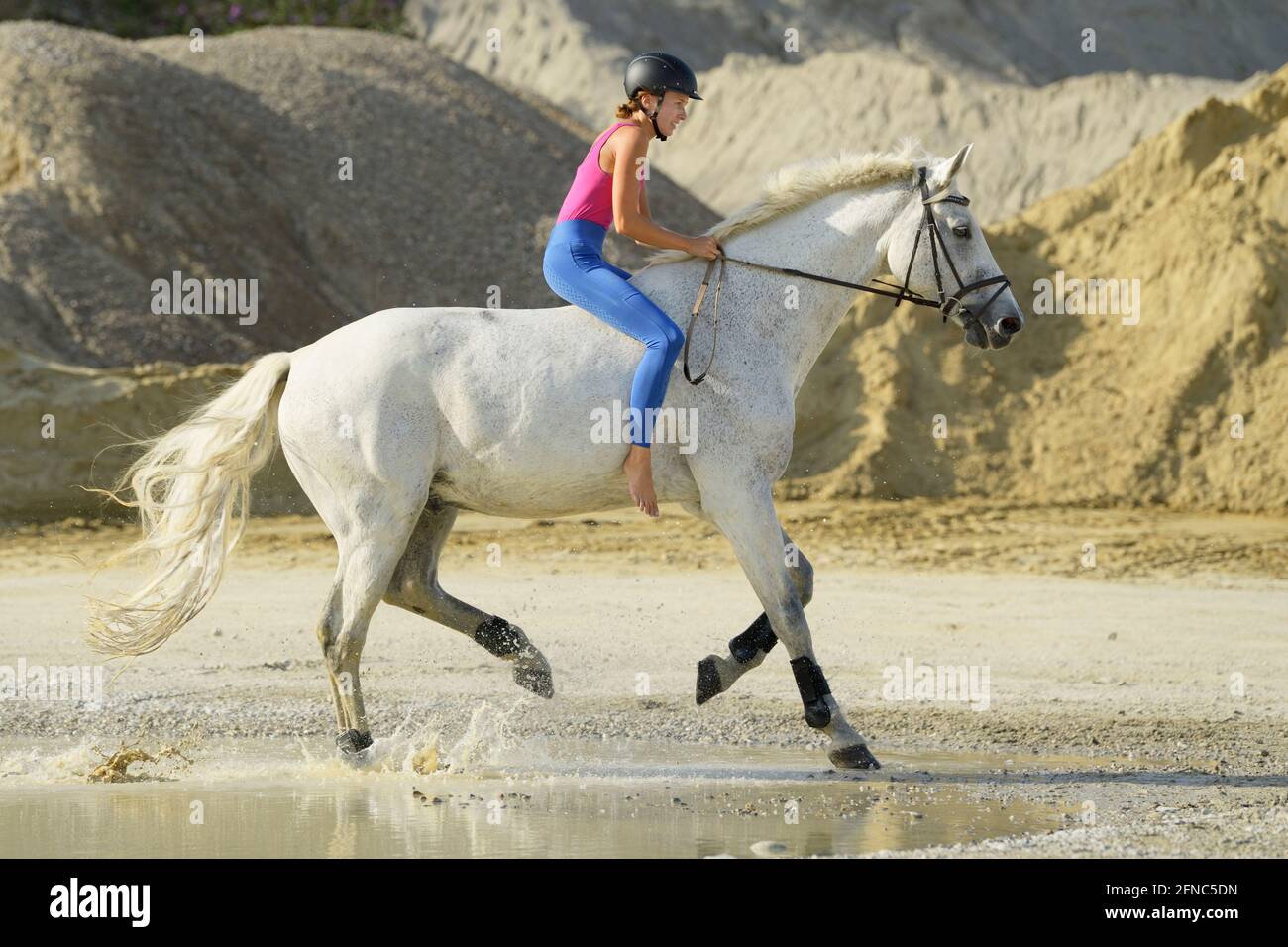Riding bareback on a Bavarian horse in a gravel pit Stock Photo