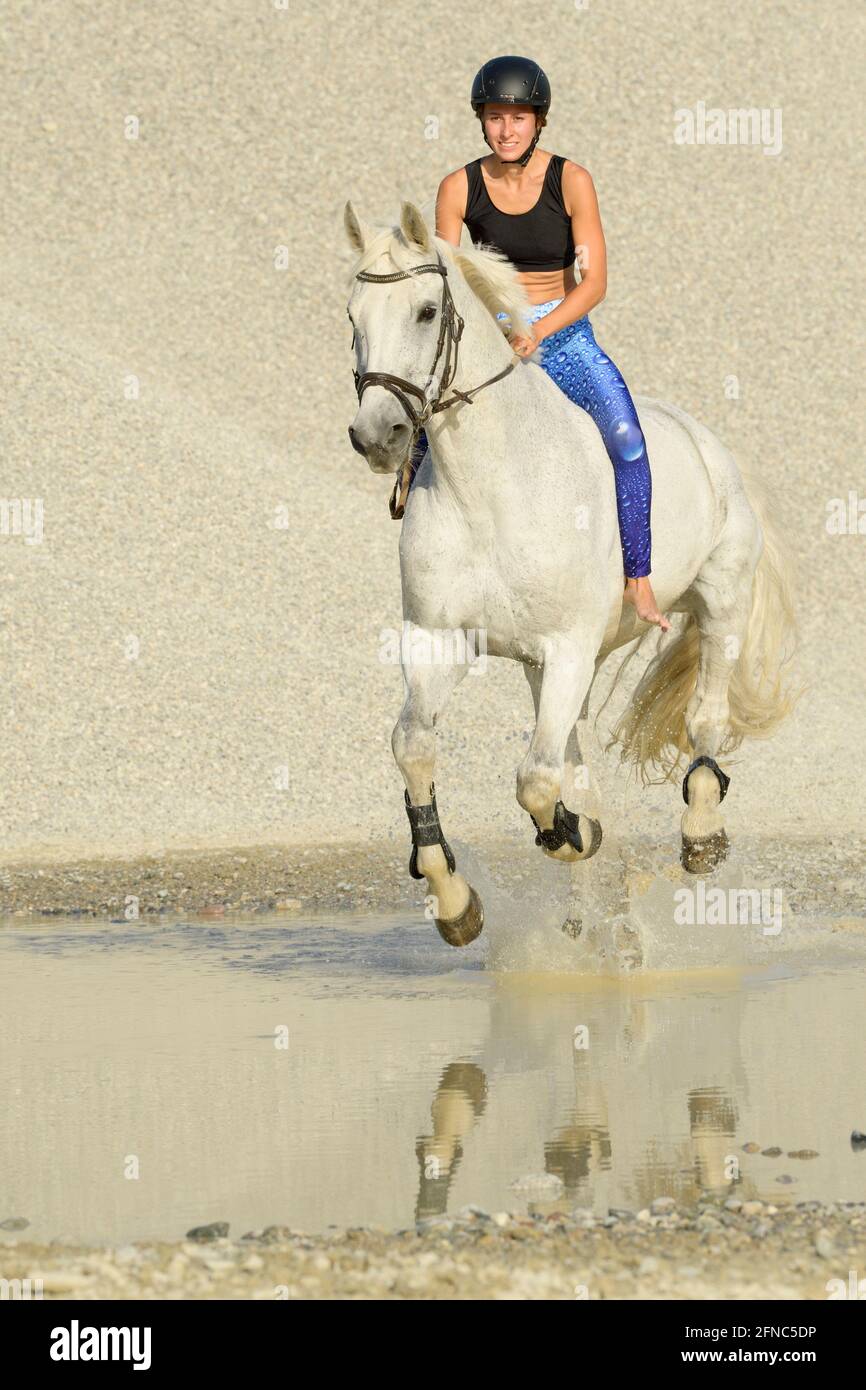 Riding bareback on a Bavarian horse in a gravel pit Stock Photo