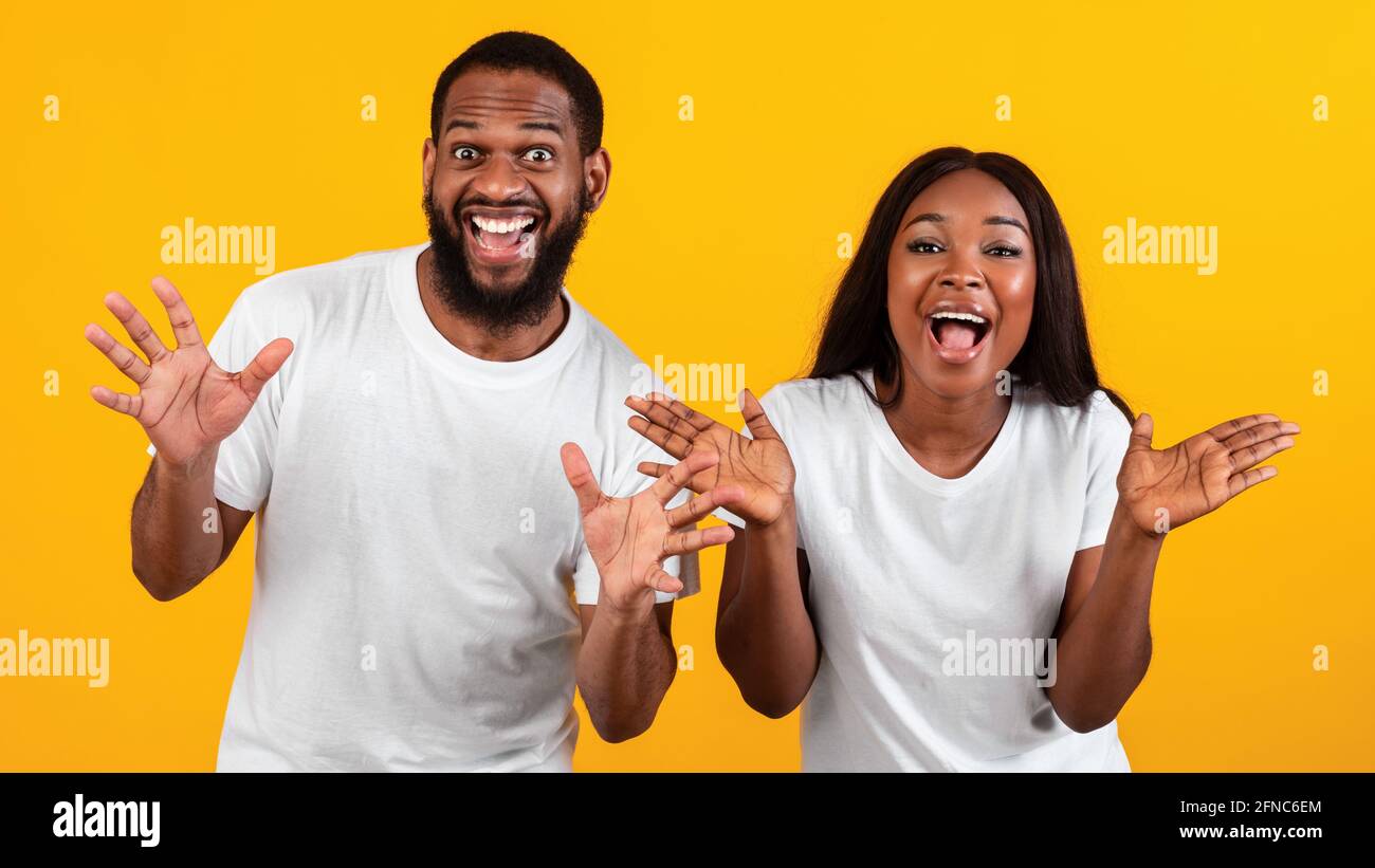 Portrait of excited black couple hearing great news Stock Photo