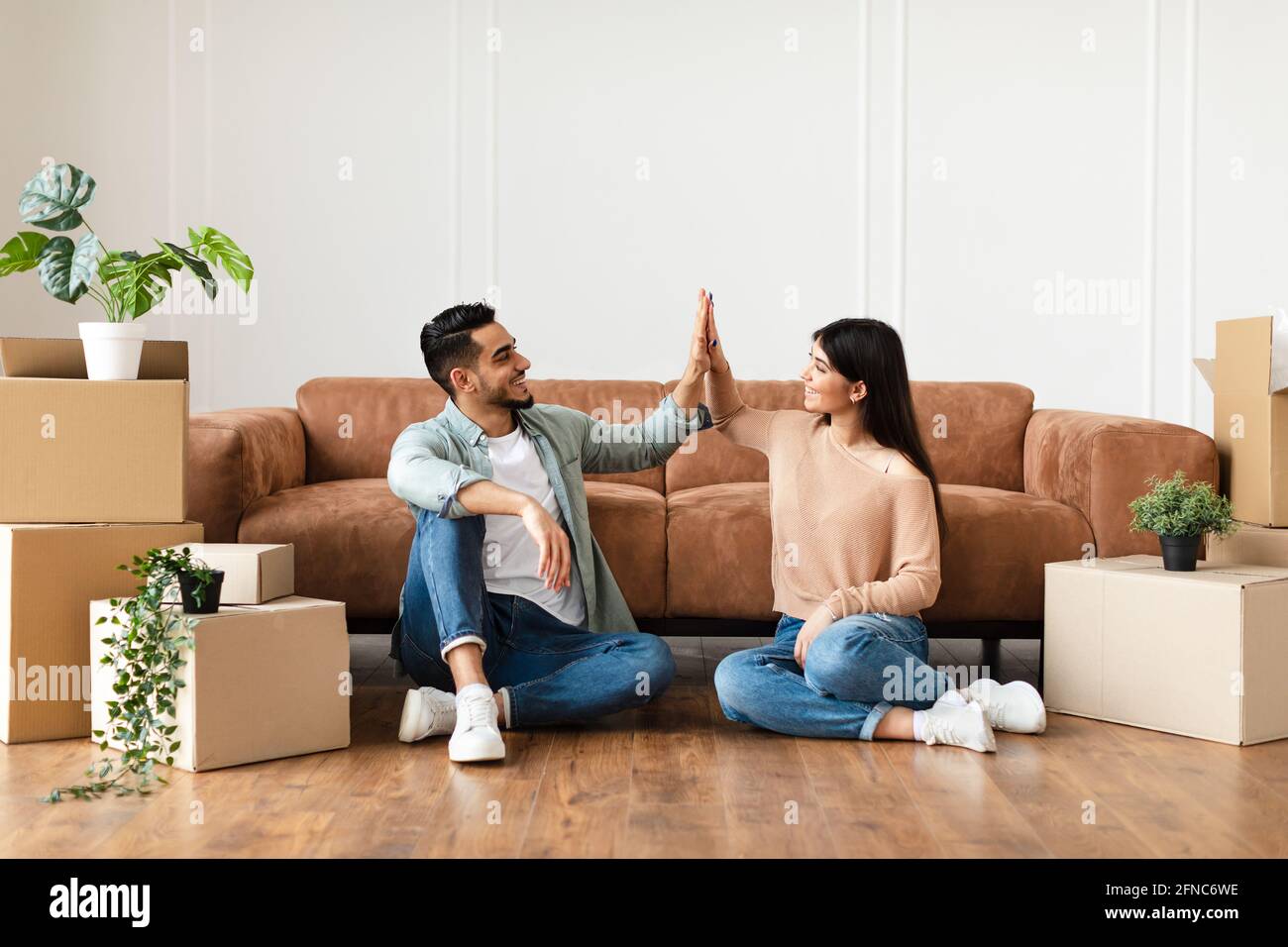 Happy man and woman giving high five Stock Photo