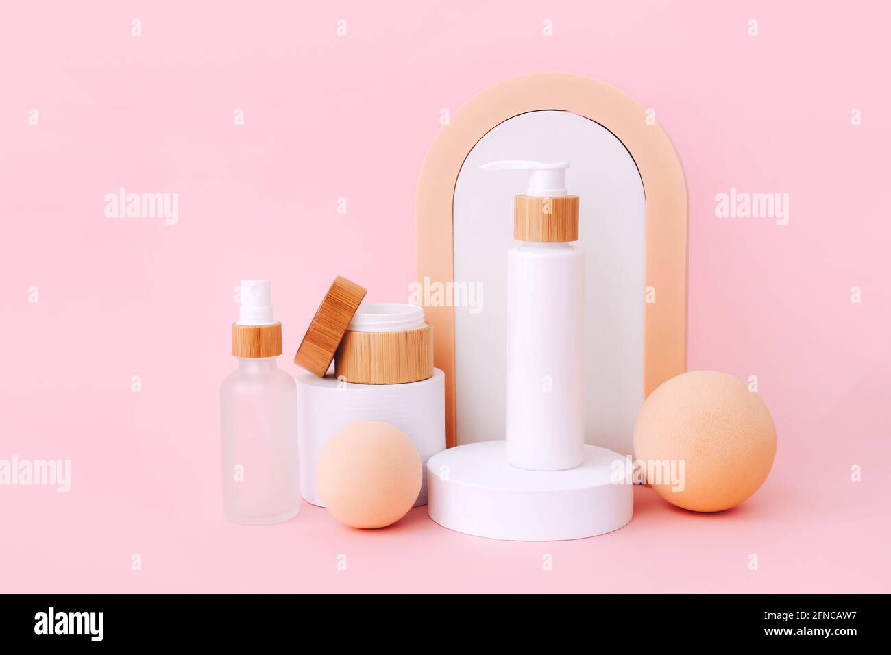 Cosmetic skin care products staying on the geometrical podiums. Product presentation on pink background. Stock Photo