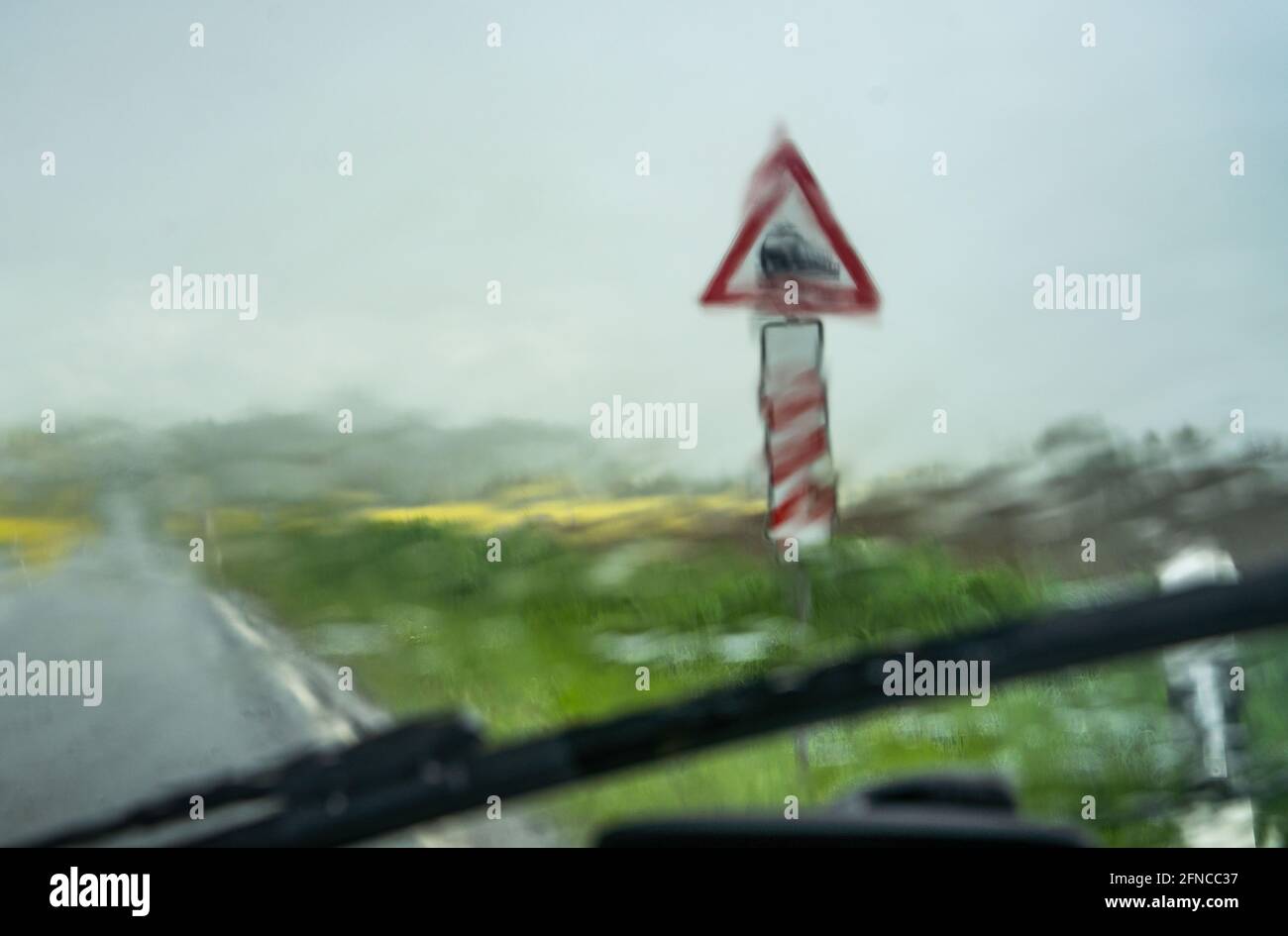 Echzell, Germany. 16th May, 2021. The windscreen wipers of a car barely manage to keep the windscreen clear during a heavy downpour on a country road in the Wetterau. The weather in Hesse will remain unsettled over the next few days. Credit: Frank Rumpenhorst/dpa/Alamy Live News Stock Photo