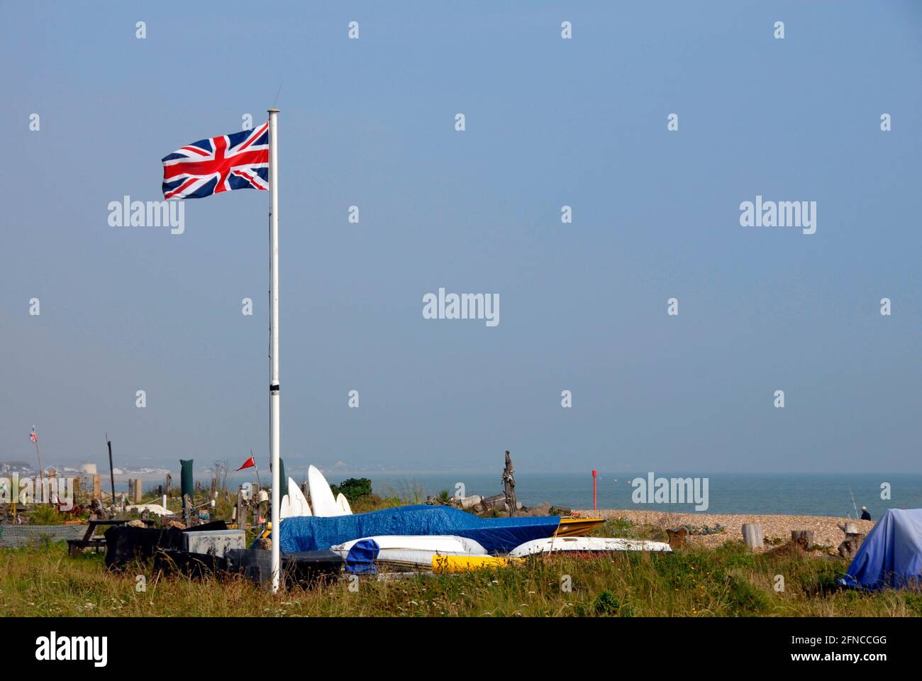 Union flag flying proudly in the breeze, Pevensey Bay beach, East Sussex, England Stock Photo