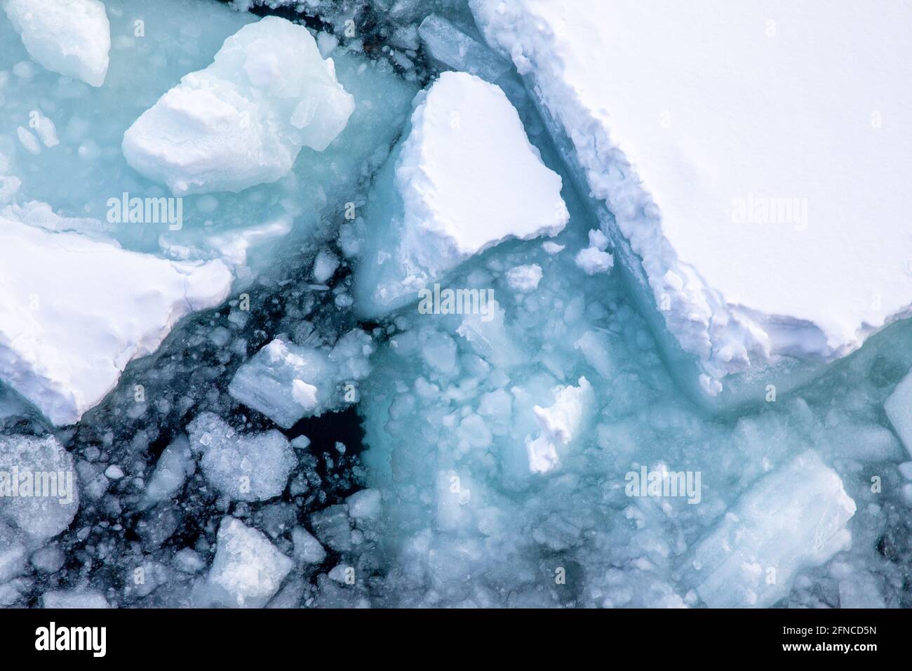 Aerial view of the Arctic Sea alongside the coast of Svalbard. Overhead  drone detail of the broken snow-covered pack ice and iceberg fragments  Stock Photo - Alamy