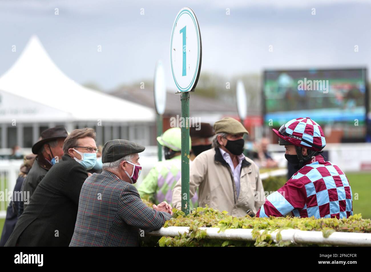 Jockey Charlie Hammond (right) speaks with owners and trainers prior to the start of the Visit racingtv.com Handicap Chase at Stratford-on-Avon Racecourse. Picture date: Sunday May 16, 2021. Stock Photo