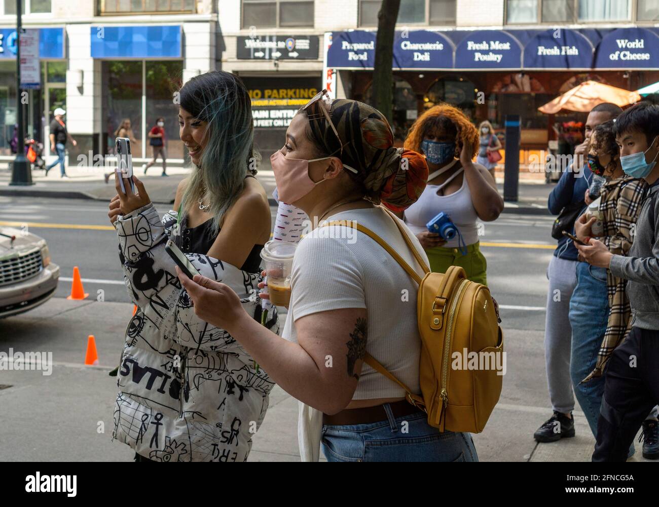 Masked and maskless people in New York on Saturday, May 15, 2021.The CDC has released new guidelines allowing the fully vaccinated to participate in indoor and outdoor activities, large or small, without wearing a mask or social distancing. (ÂPhoto by Richard B. Levine) Stock Photo