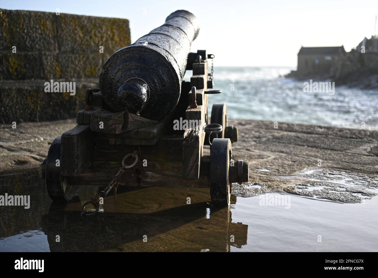 old cannon from the middle ages pointing out to sea, 13th century weaponry icon Stock Photo