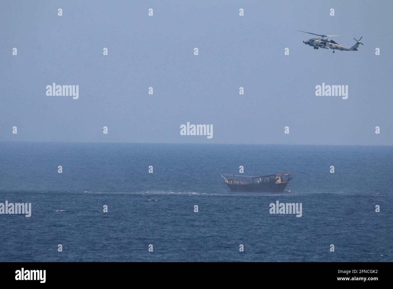 This photo, released on May 6, 2021, shows an SH-60 Seahawk helicopter assigned to the guided-missile cruiser USS Monterey (CG 61)(not shown) flies above a stateless dhow interdicted with a shipment of illicit weapons in international waters of the North Arabian Sea on May 6-7. As conducted by the U.S. Fifth Fleet, maritime security operations entail routine patrols to determine the pattern of life in the maritime and enhance mariner-to-mariner relations. These operations reassure allies and partners and preserve freedom of navigation and free flow of commerce. Photo by U.S. Navy/UPI Stock Photo
