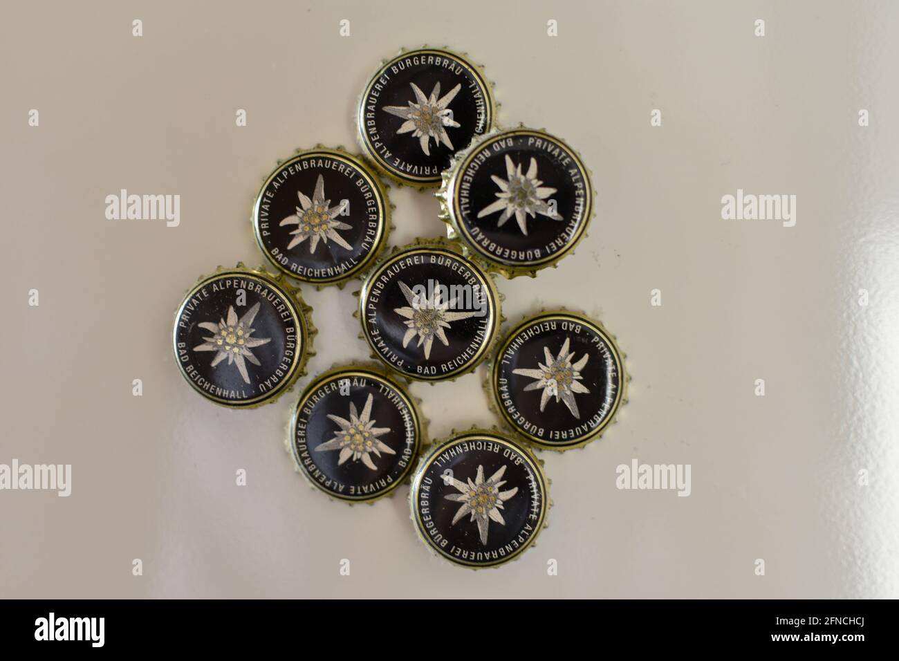 Bad Reichenhall, Germany - May 15, 2021: beer bottle caps of Buergerbraeu Bad Reichenhall brewery with Edelweiss wildflower as decoration Stock Photo
