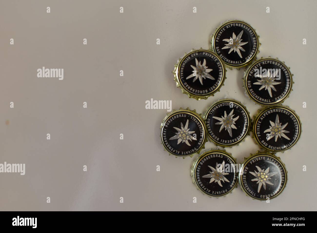Bad Reichenhall, Germany - May 15, 2021: beer bottle caps of Buergerbraeu Bad Reichenhall brewery with Edelweiss wildflower as decoration Stock Photo