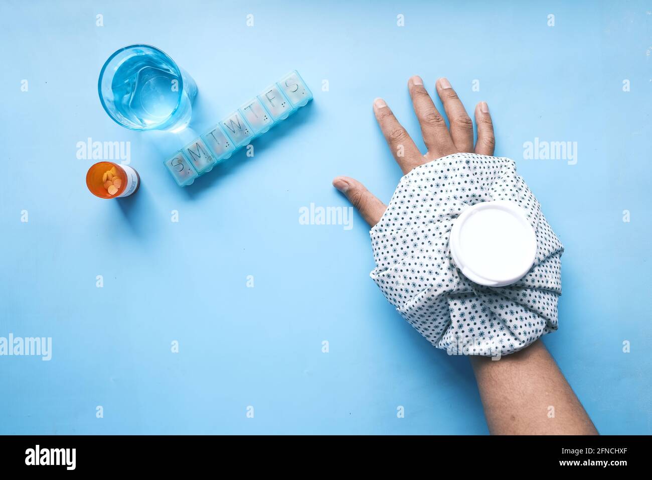 Young man hands suffering wrist pain, and applying cold water on injury