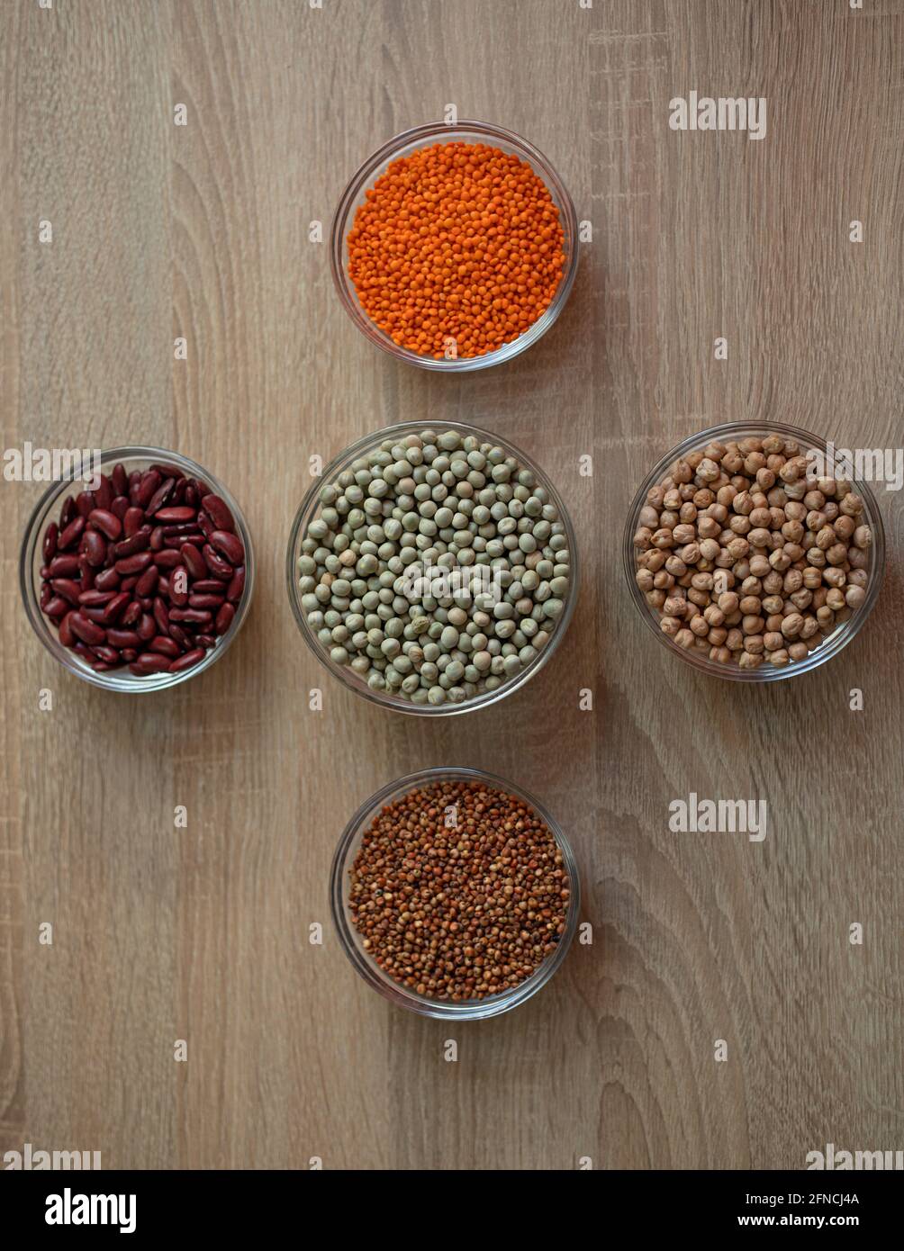 Bowls of cereal grains chickpeas, red lentils, red bean, green peas