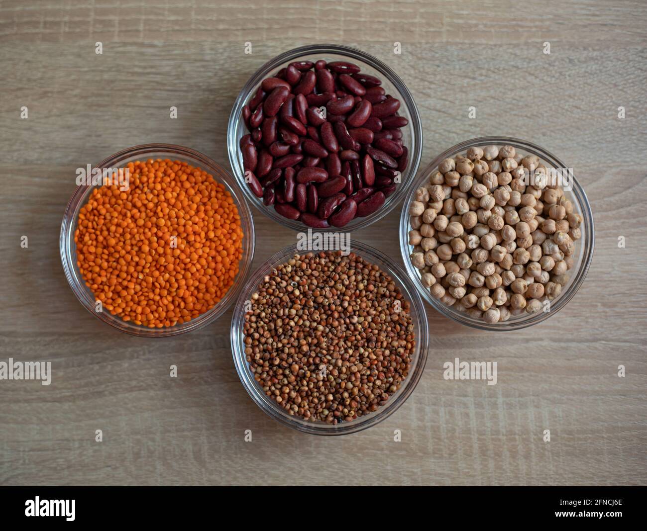 Bowls of cereal grains: chickpeas, red lentils, red bean, sorghum grain Stock Photo