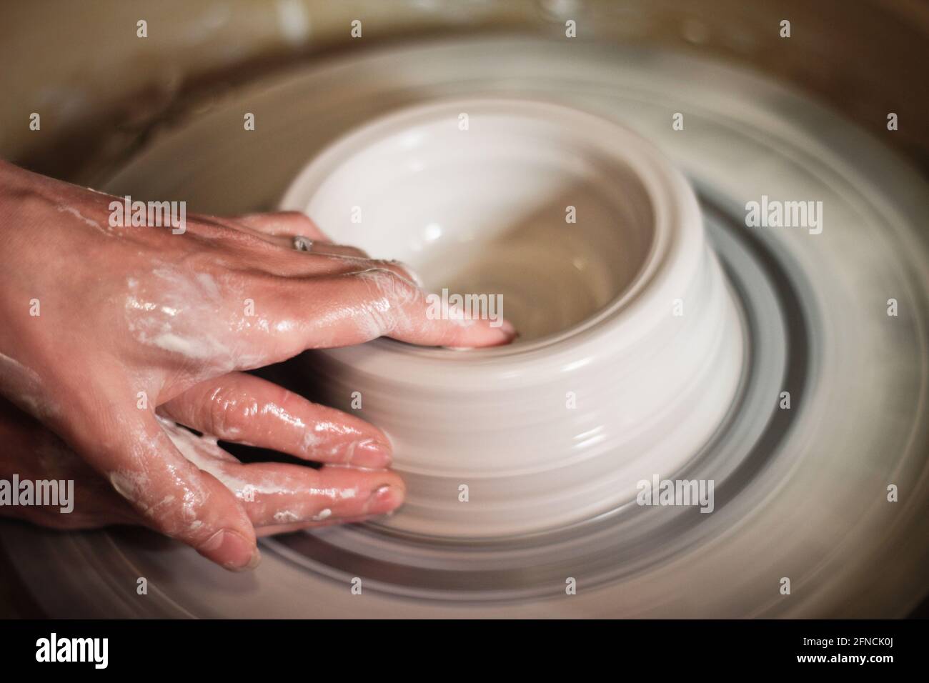 woman rotating wheel clay making of handmade craftsmanship Stock Photo