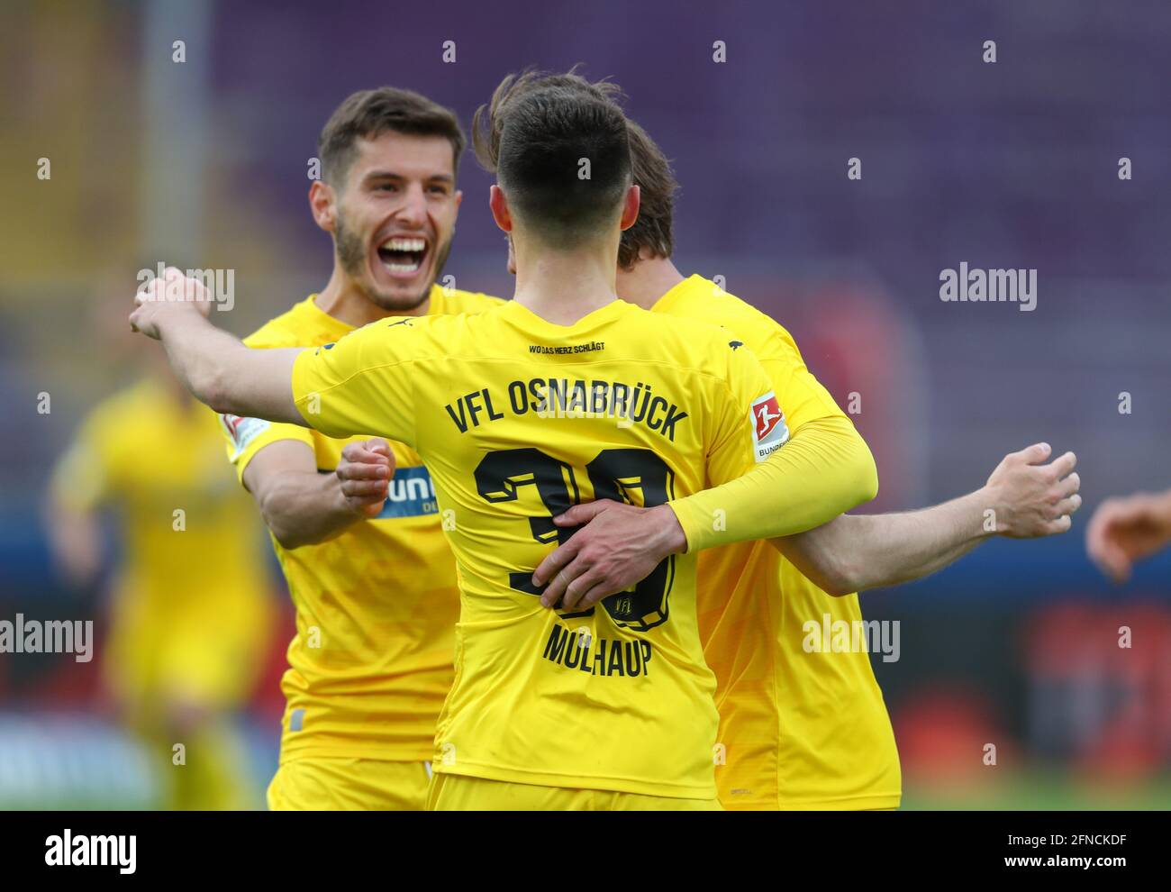 16 May 2021, Lower Saxony, Osnabrück: Football: 2nd Bundesliga, VfL Osnabrück - Hamburger SV, 33rd matchday at Stadion an der Bremer Brücke. Osnabrück's goal scorer Maurice Multhaup (centre) celebrates his goal to make it 2:1 with Bashkim Ajdini (l). Photo: Friso Gentsch/dpa - IMPORTANT NOTE: In accordance with the regulations of the DFL Deutsche Fußball Liga and/or the DFB Deutscher Fußball-Bund, it is prohibited to use or have used photographs taken in the stadium and/or of the match in the form of sequence pictures and/or video-like photo series. Stock Photo