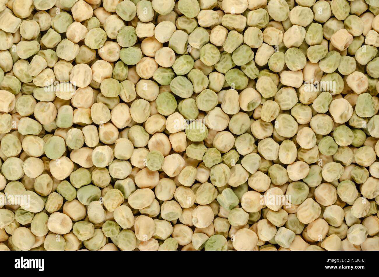 Snow pea seeds, background, from above. Also Chinese pea or pois mangetout, an edible-pod pea with flat pods and thin pod walls. Stock Photo