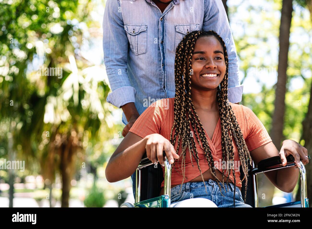 Woman in a wheelchair at the park with her boyfriend Stock Photo - Alamy
