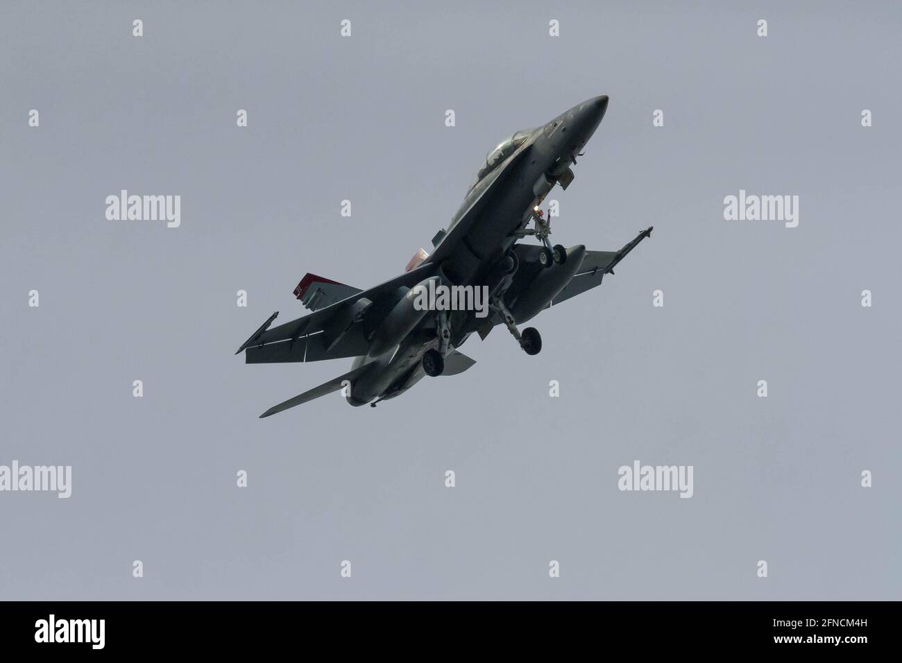 A McDonnell Douglas F/A-18D Hornet with the Marine Fighter Attack Squadron 232 (VMFA-232) known as The Red Devils flies near NAF Atsugi airbase in Kanagawa. Stock Photo