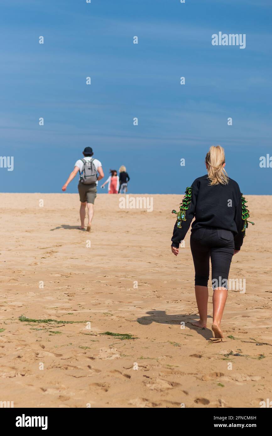 A family enjoying Rock Beach during the summer holidays in Cornwall. Stock Photo