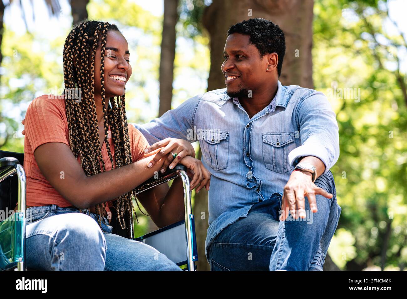 Woman in a wheelchair at the park with her boyfriend Stock Photo - Alamy