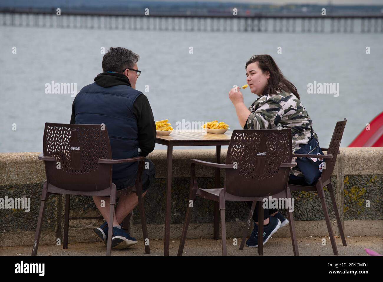 Southend on Sea Essex England UK 15 May 2021 Sitting on the sea wall eating chips on Southend sea Front. Stock Photo