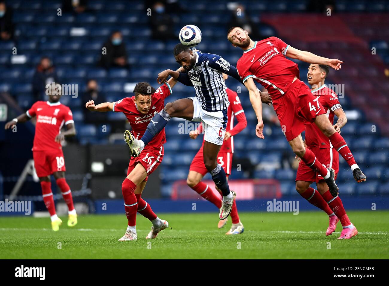 West Bromwich Albion's Semi Ajayi (centre) battles for the ball with Liverpool's Rhys Williams and Nathaniel Phillips (right) during the Premier League match at The Hawthorns, West Bromwich. Picture date: Sunday May 16, 2021. Stock Photo