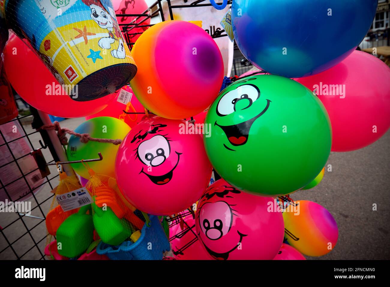 Southend on Sea Essex England UK 15 May 2021 Colourful plastic beach balls for sale with smiley face. Stock Photo