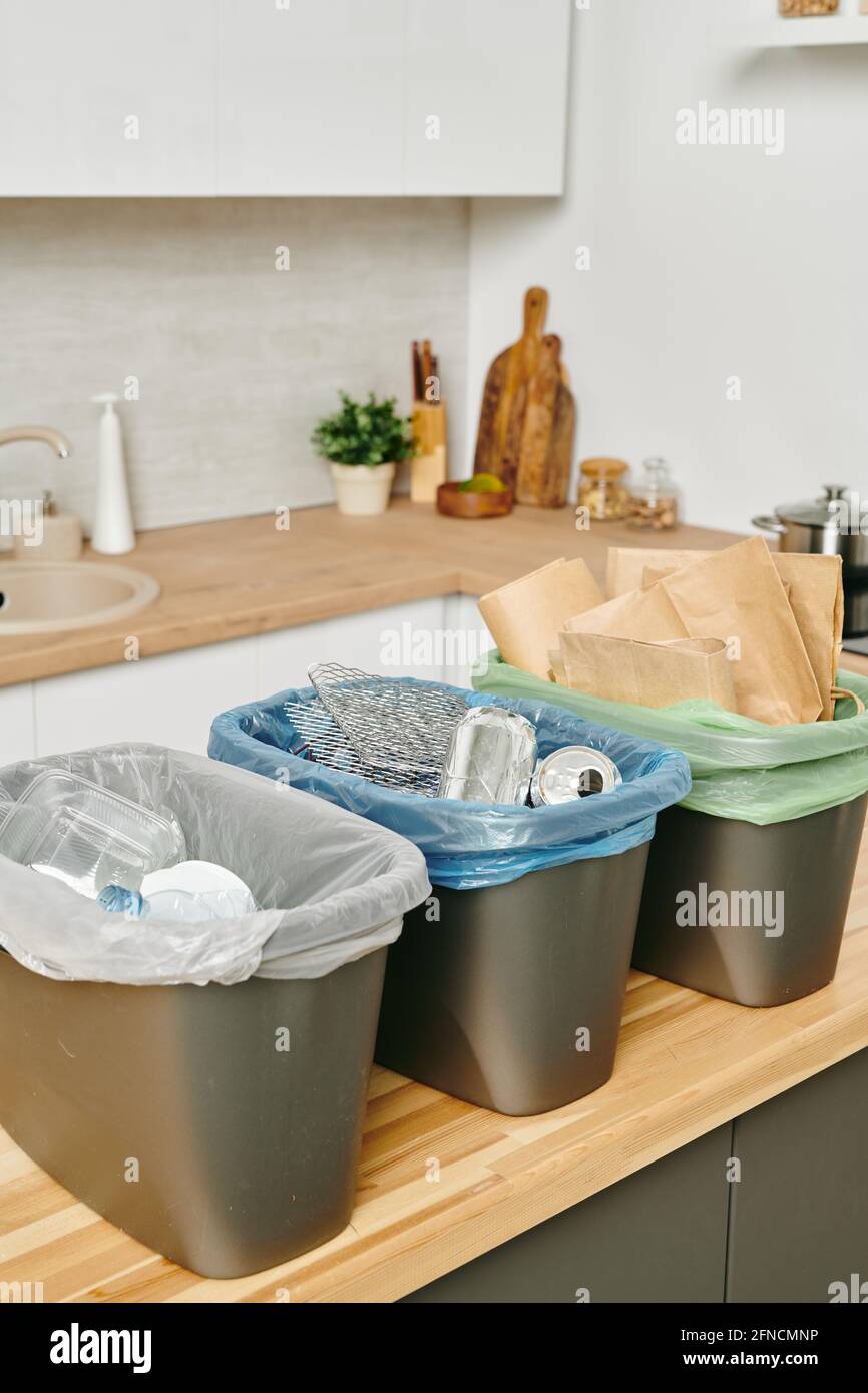 Group of plastic buckets for waste standign on kitchen table Stock