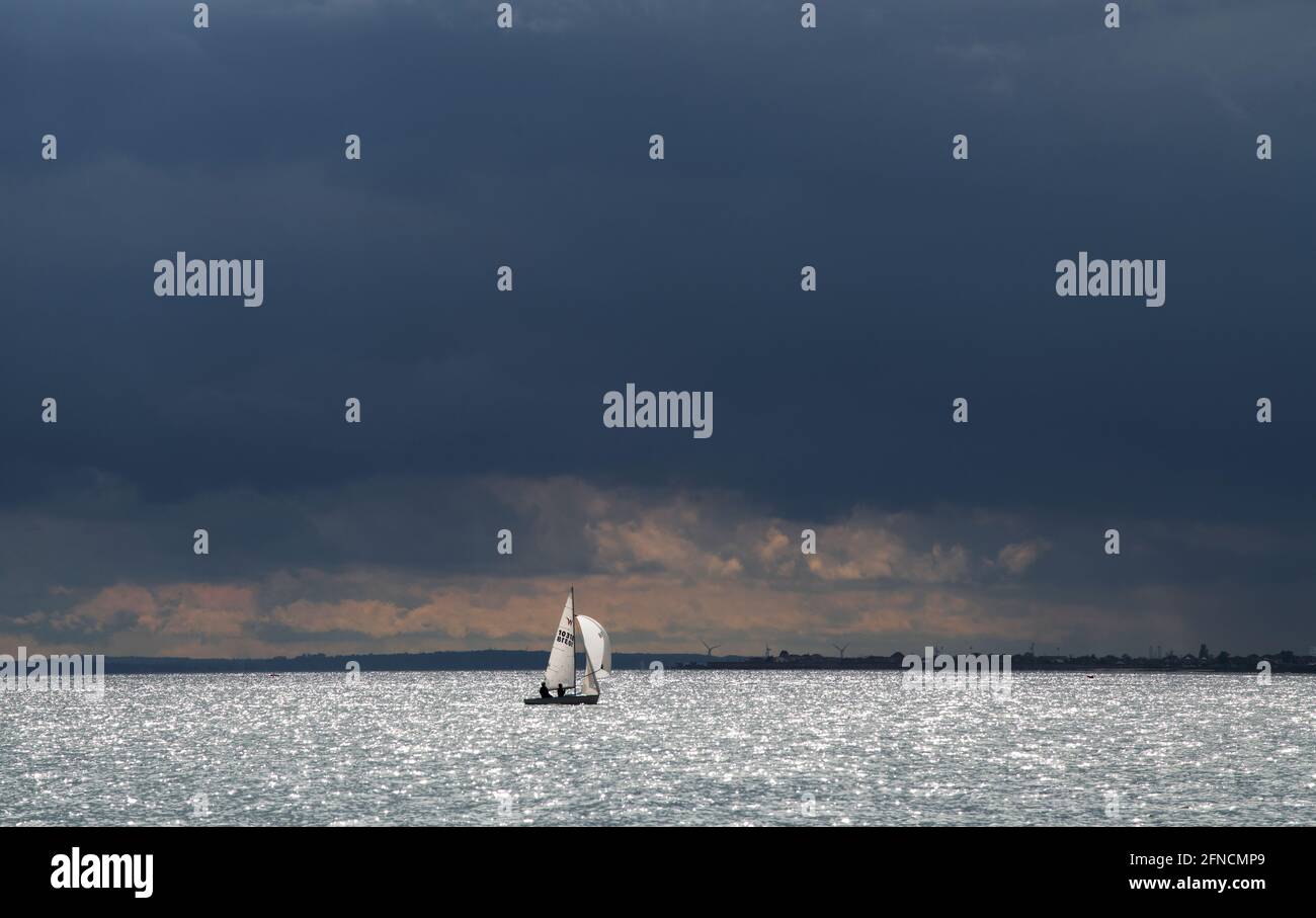 Southend on Sea Essex England UK 15 May 2021 Yacht sailing on the Thames Estuary under a threatening sky at Southend on Sea. Stock Photo