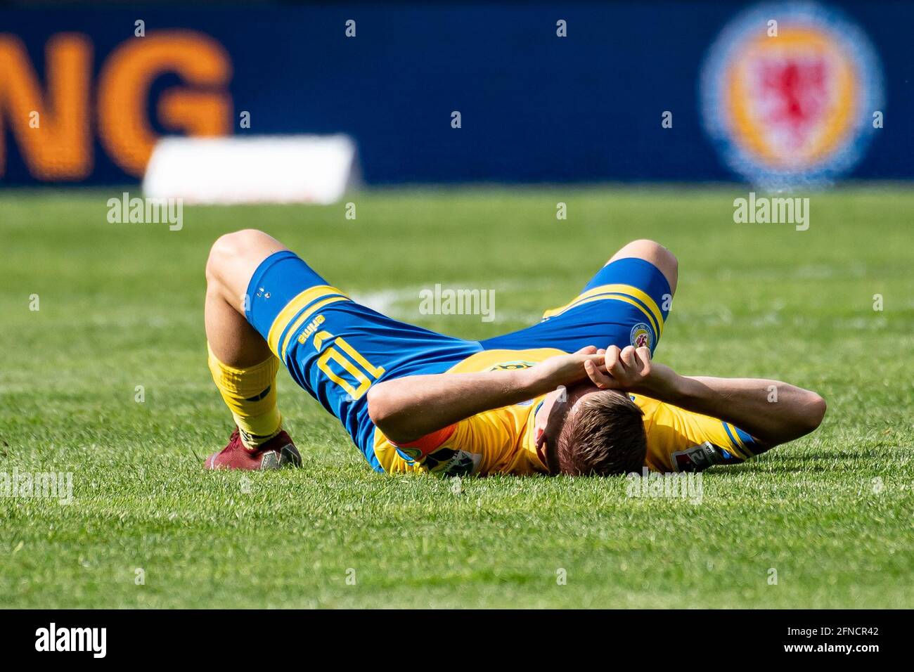 Brunswick, Germany. 16th May, 2021. Football: 2. Bundesliga, Eintracht  Braunschweig - Würzburger Kickers, 33. matchday at Eintracht-Stadion.  Braunschweig's Martin Kobylanski lies on the field after the end of the  match. Credit: Swen
