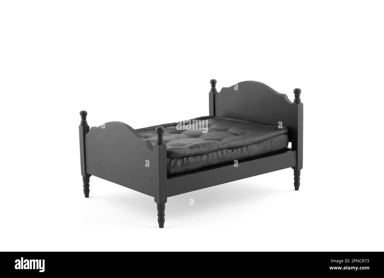 Black wooden bed miniature on white background with clipping path Stock