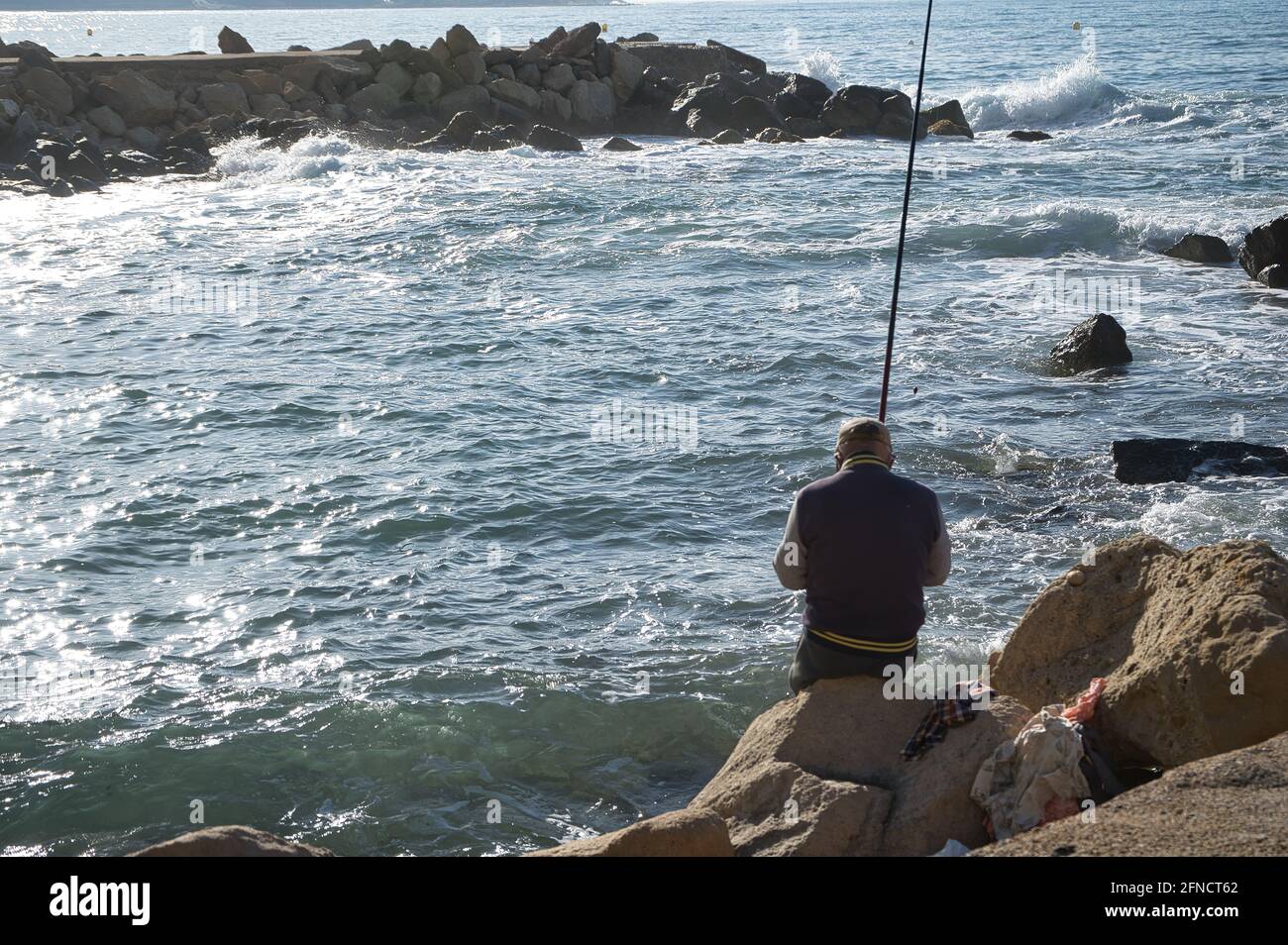 Person in between rocks hi-res stock photography and images - Alamy