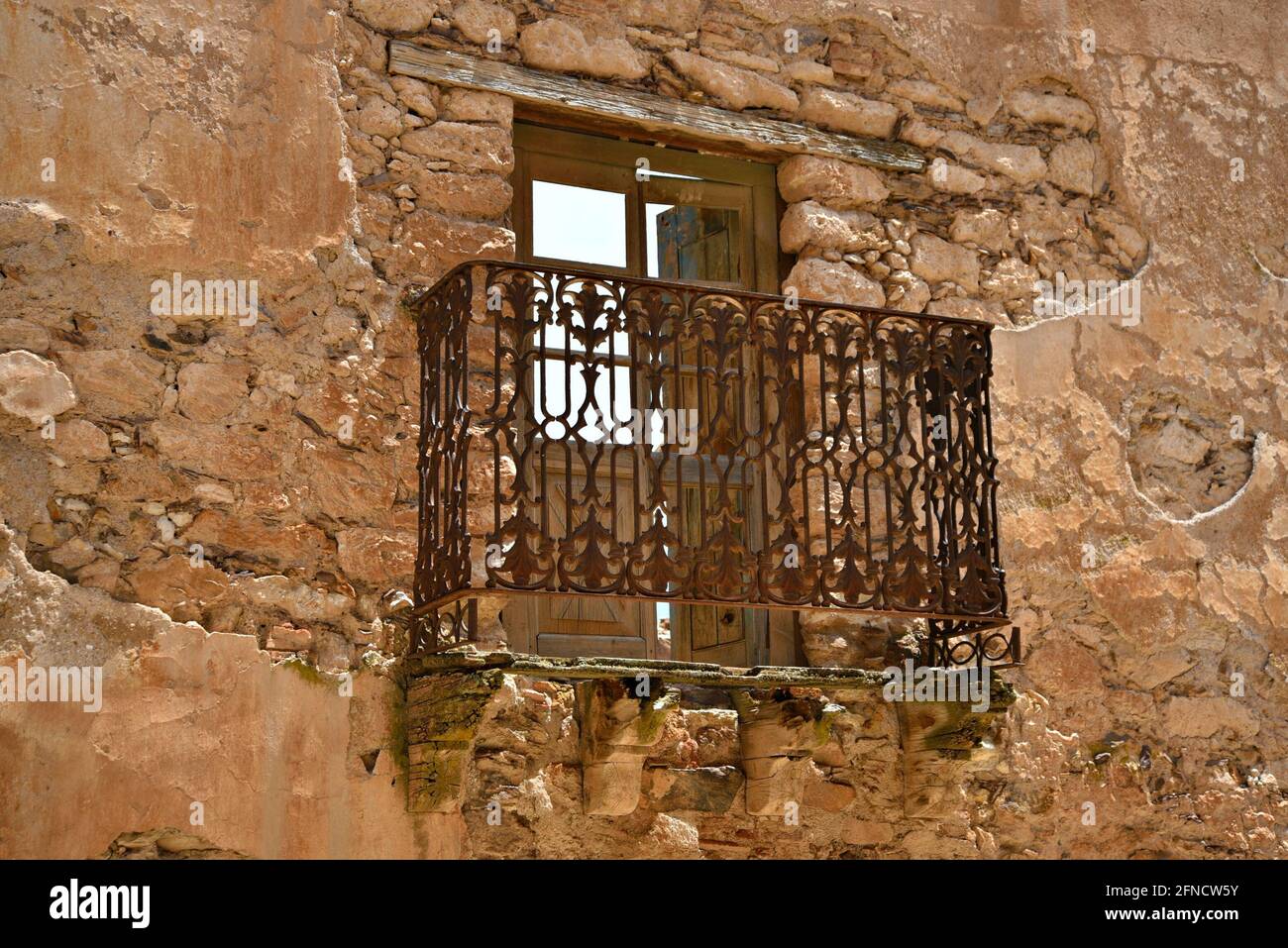 Old abandoned building balcony with a rusty iron railing on a ...