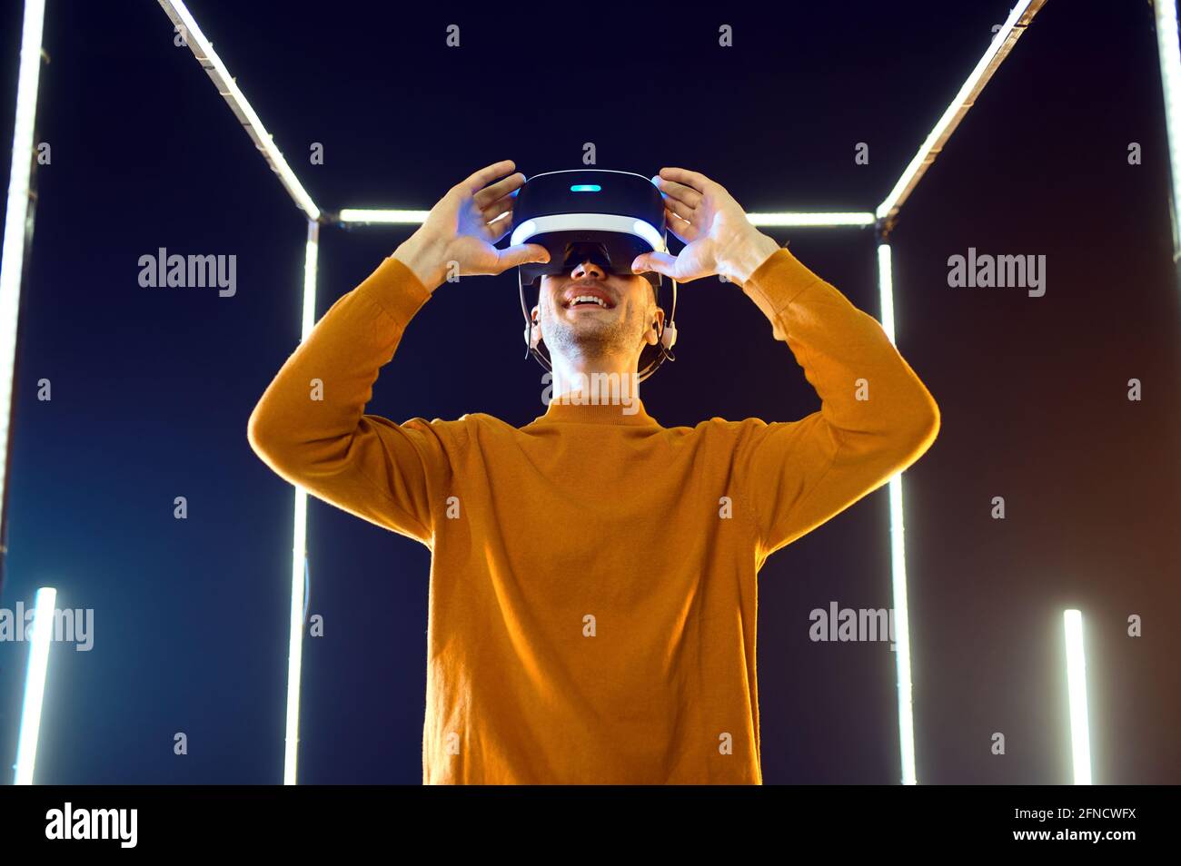 Male gamer using virtual reality headset Stock Photo