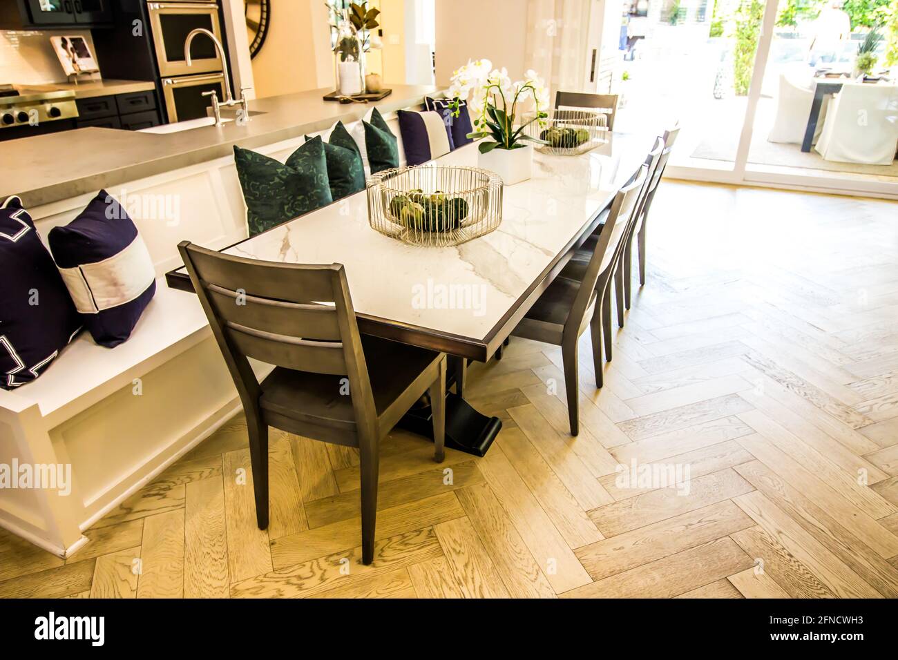 Modern Oblong Dining Table With Chairs And BuiltIn Bench Stock Photo