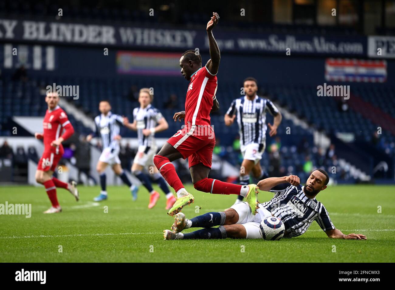 West Bromwich Albion's Matt Phillips (right) tackles Liverpool's Sadio Mane during the Premier League match at The Hawthorns, West Bromwich. Picture date: Sunday May 16, 2021. Stock Photo