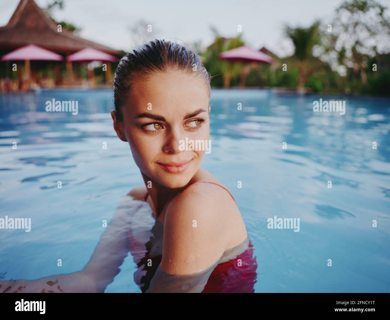 portrait of woman with wet hair in pool cropped view Stock Photo