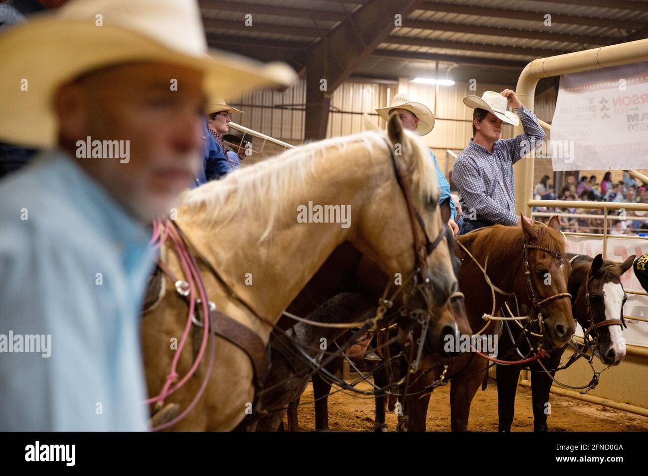 Participants in the team roping competition wait for their turn at the