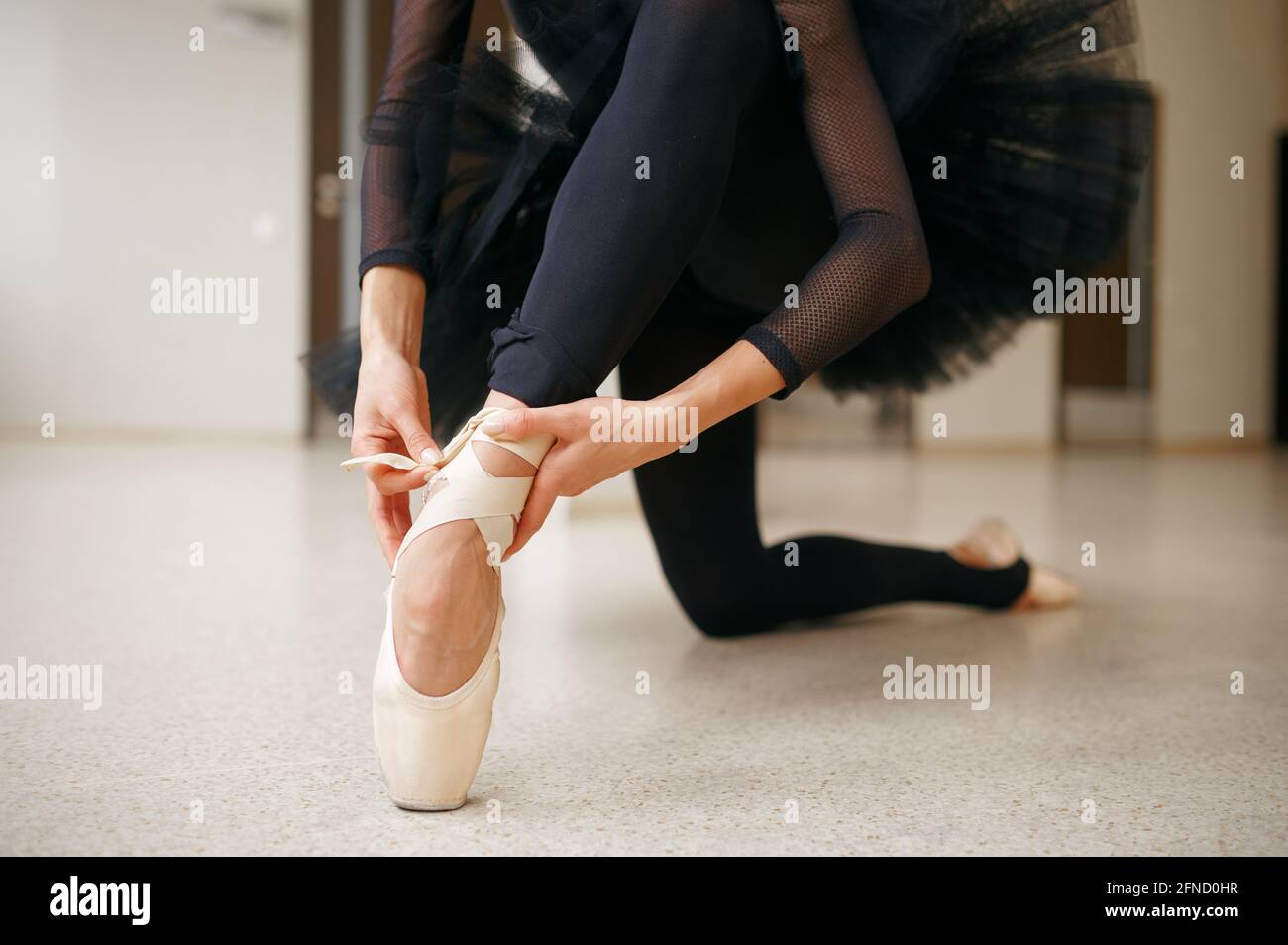 Ballerina doing stretching exercise in class Stock Photo