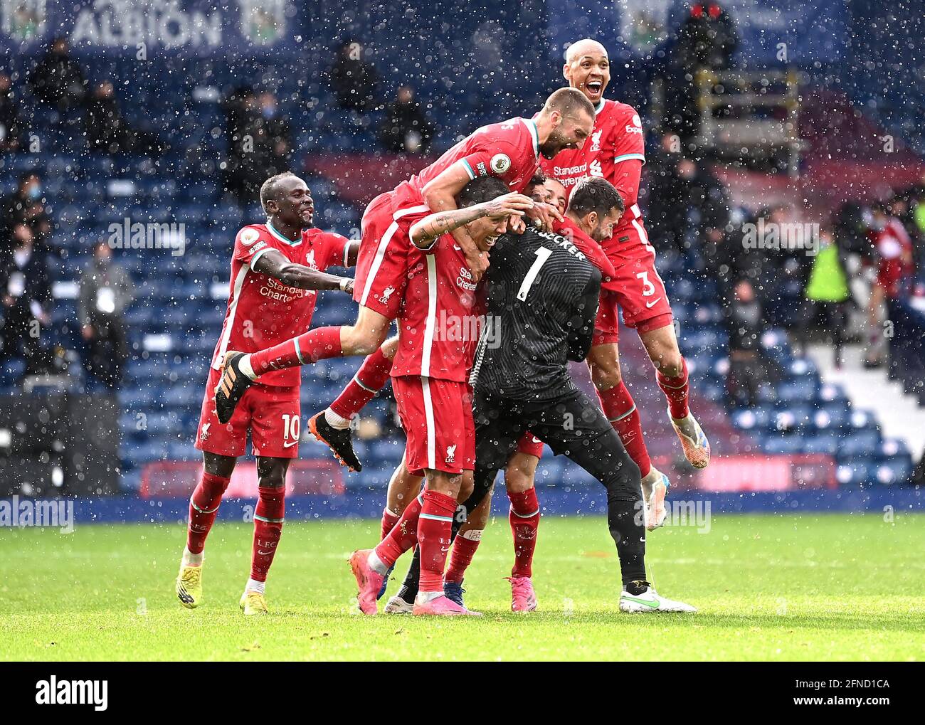 Liverpool goalkeeper Alisson celebrates scoring their side's second goal of the game with team-mates during the Premier League match at The Hawthorns, West Bromwich. Picture date: Sunday May 16, 2021. Stock Photo