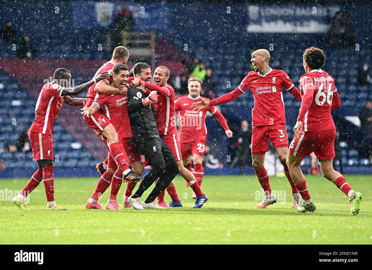Liverpool goalkeeper Alisson celebrates scoring their side's second goal of the game with team-mates during the Premier League match at The Hawthorns, West Bromwich. Picture date: Sunday May 16, 2021. Stock Photo