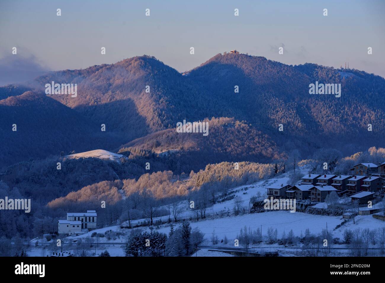 Snowy sunrise over the town and valley of Molló, seen from La Ginestosa. In the background, the Serra Cavallera (Ripollès, Catalonia, Spain, Pyrenees) Stock Photo